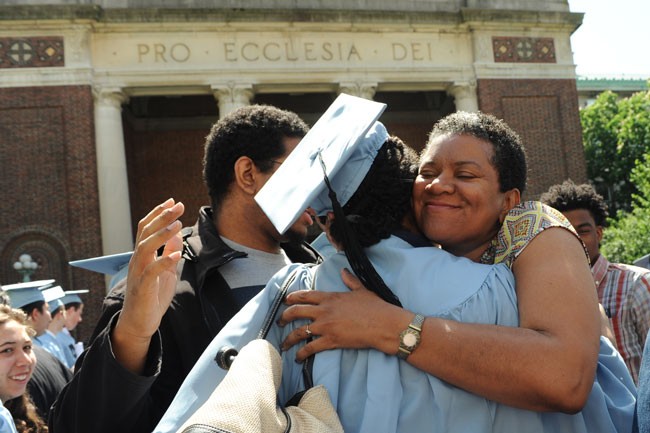 mother hugging graduate
