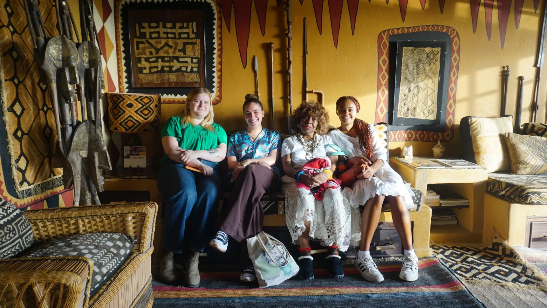 Fellows Ava, Safia and Esther join Chaplain Davis for a photo at the African Heritage House. 