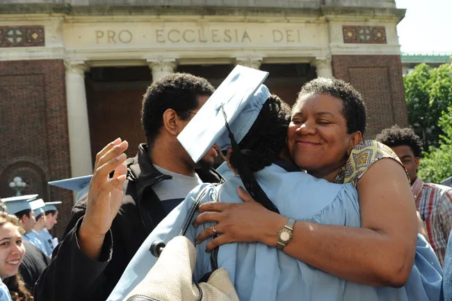 mother hugging graduate